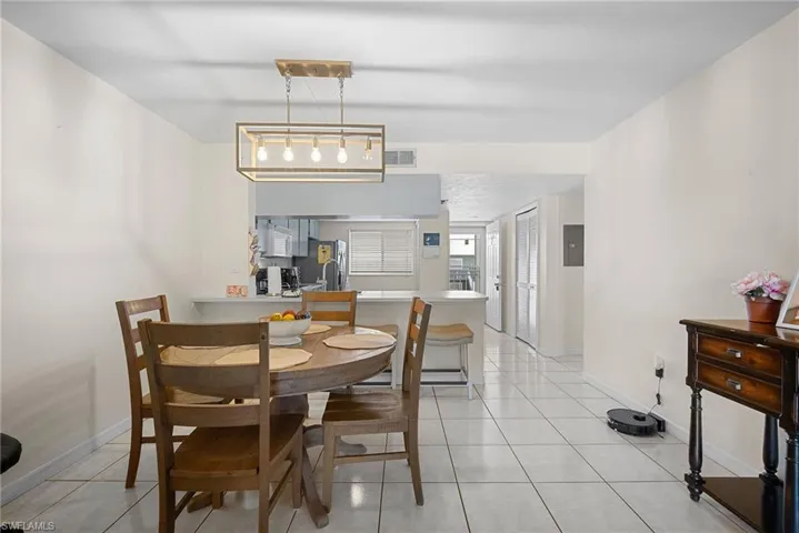 Dining space featuring light tile patterned floors