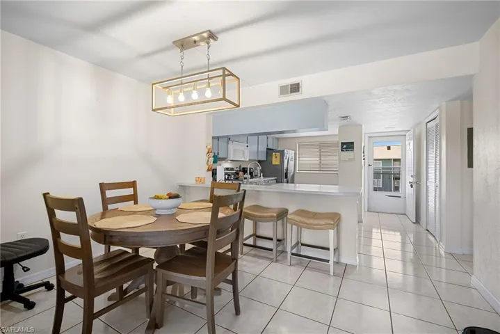 Dining space featuring light tile patterned floors and baseboards