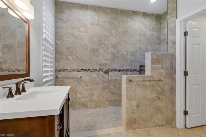 Full bath with vanity and a walk in shower
