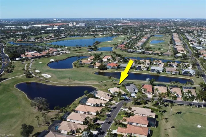 Aerial overview of property's location featuring a local golf course, nearby suburban area, and a nearby body of water