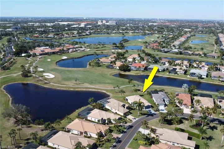 Aerial view of property's location with nearby suburban area and a golf course