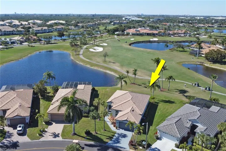 Aerial perspective of suburban area with a golf club and a nearby body of water