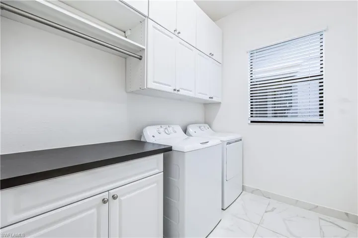 Laundry room with cabinets and washer and dryer