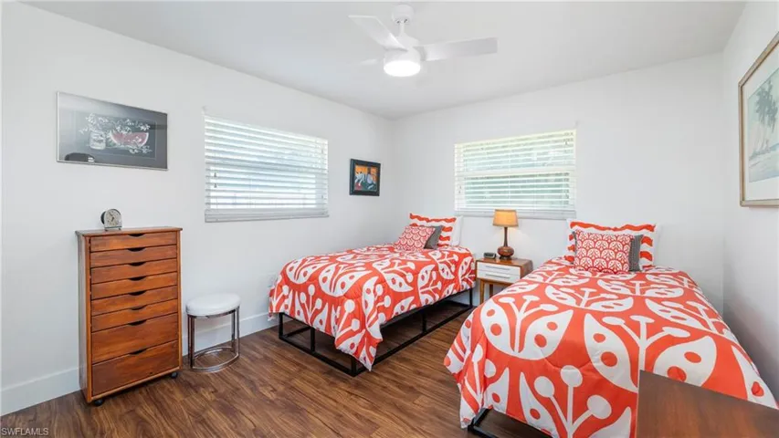 Bedroom featuring dark wood-style floors and a ceiling fan