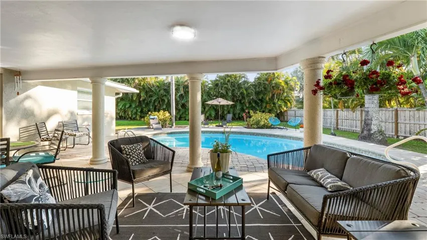 View of swimming pool with an outdoor living space, patio surround, and a fenced backyard