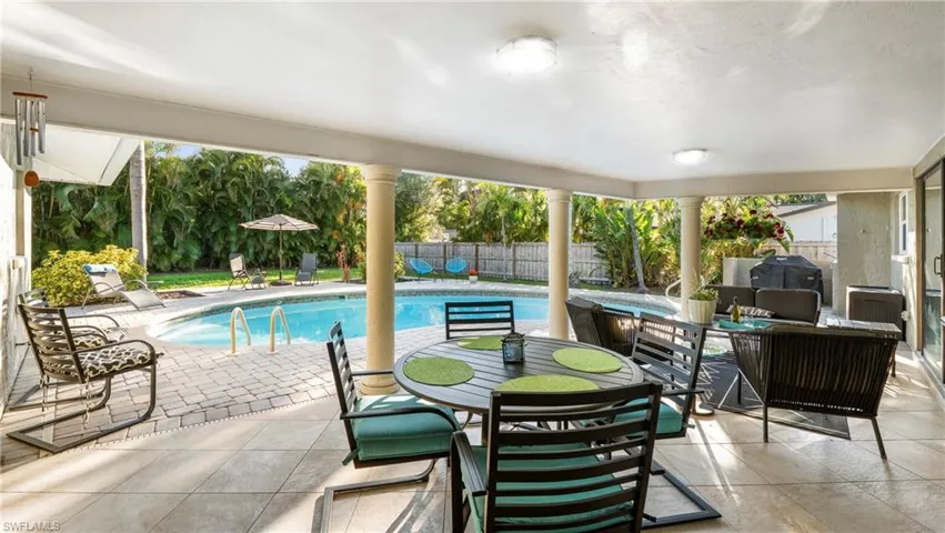 View of swimming pool featuring patio surround, a fenced backyard, a jacuzzi, and outdoor lounge area