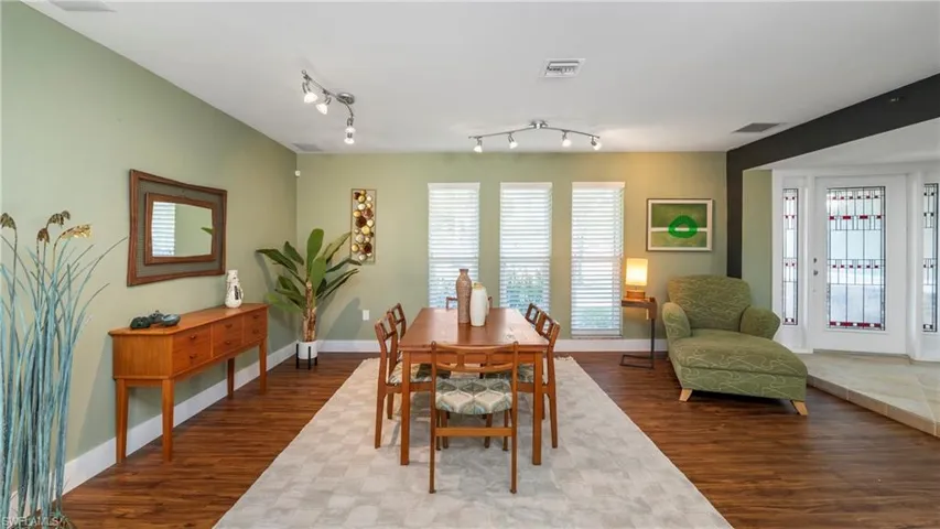 Dining area featuring dark wood-style flooring