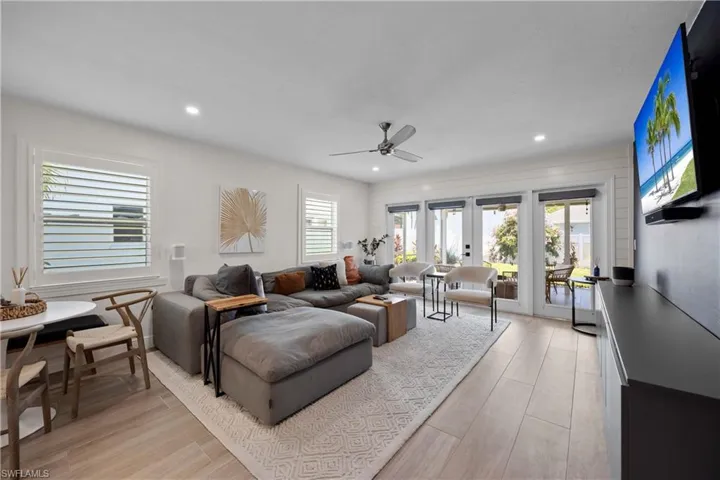 Living room featuring ceiling fan, light hardwood / wood-style flooring, and french doors