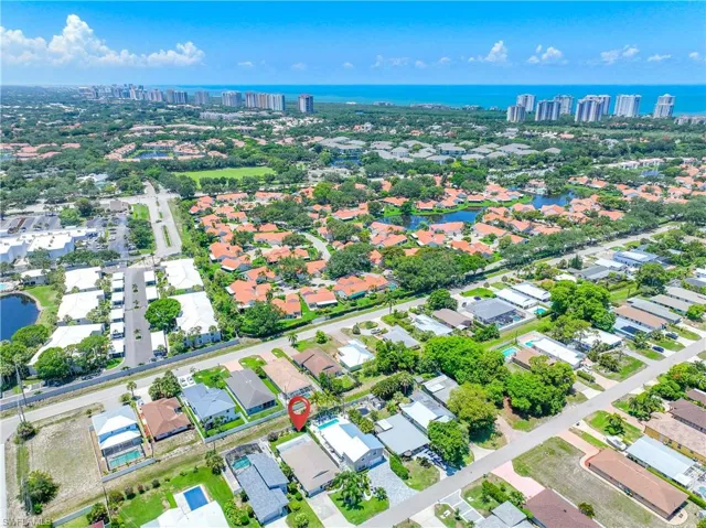 Birds eye view of property with a water view
