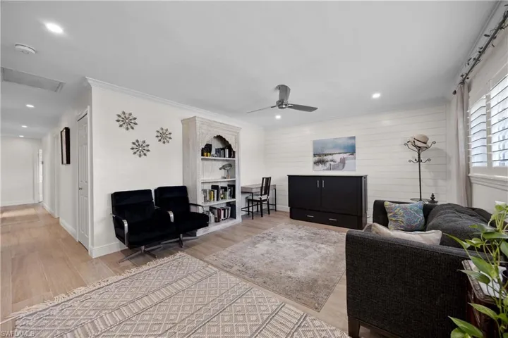 Living room with ornamental molding, ceiling fan, and hardwood / wood-style floors