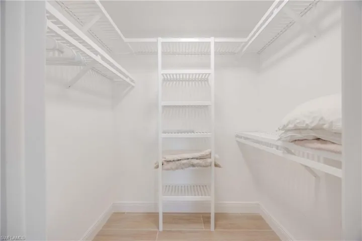 Spacious closet with light hardwood / wood-style floors