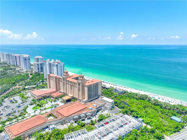 Birds eye view of property featuring a view of the beach and a water view