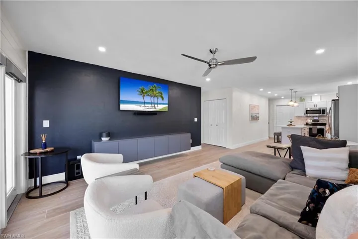 Living room featuring ceiling fan and light hardwood / wood-style flooring
