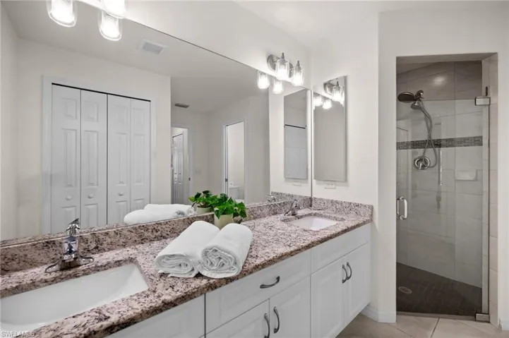 Primary Bathroom with Dual Sinks and Tile and Glass shower