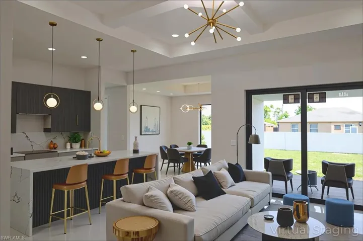 Living area featuring a chandelier, beam ceiling, and recessed lighting