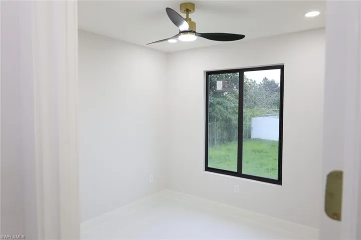 Empty room with ceiling fan and recessed lighting