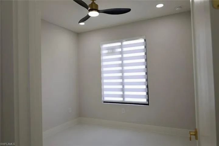 Empty room with a ceiling fan and recessed lighting