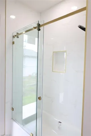 Full bathroom featuring a marble finish shower