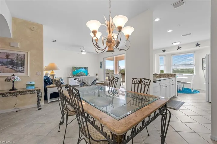Tiled dining area featuring plenty of natural light