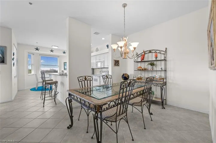 Tiled dining room with a chandelier