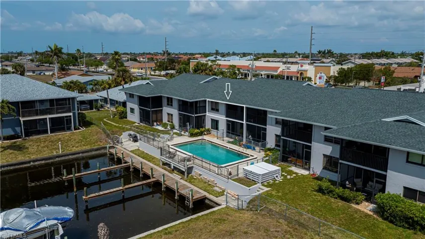 Aerial view of residential area featuring a pool area