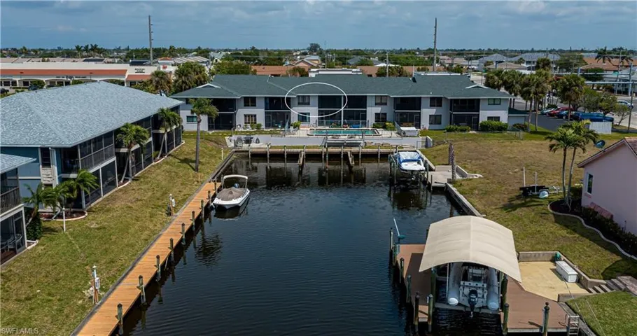 Aerial perspective of suburban area featuring a nearby body of water