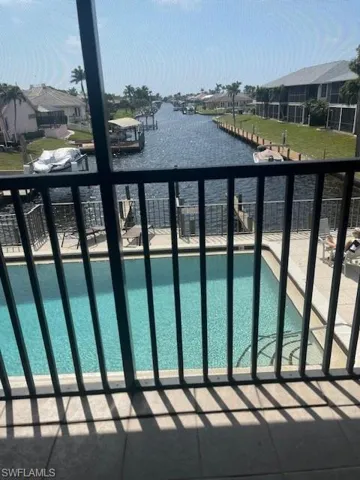 Community pool with a balcony and a water view