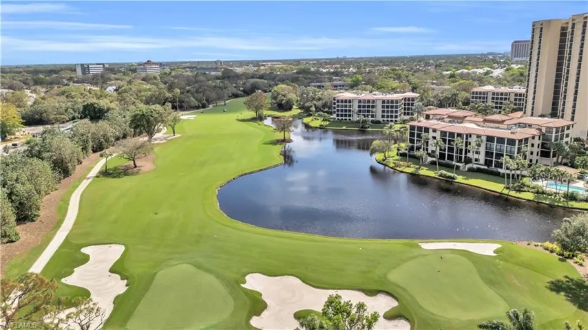 Aerial view of a golf course and a nearby body of water
