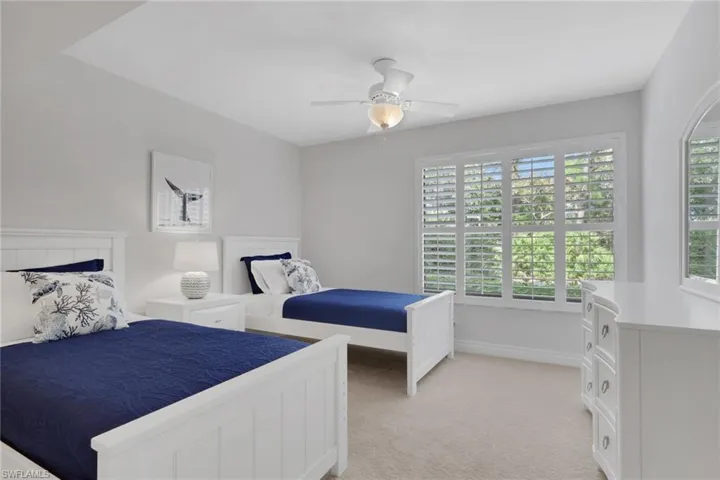 Bedroom featuring light colored carpet and ceiling fan