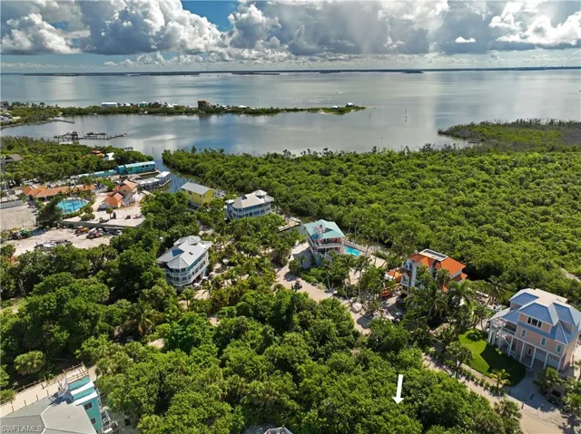 Birds eye view of property with a water view