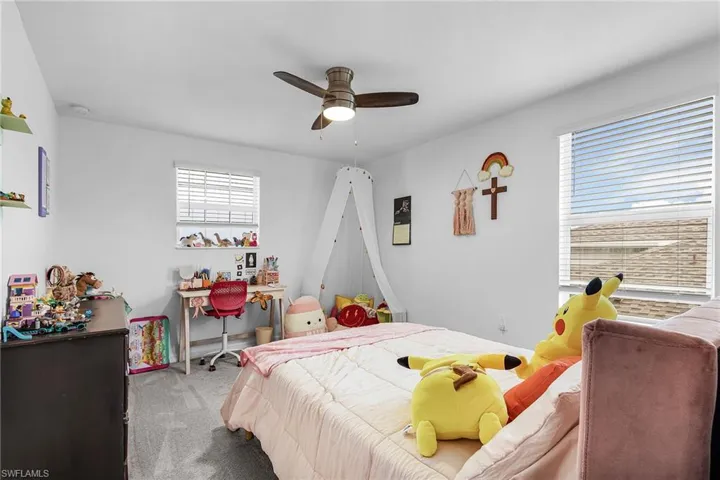 Carpeted bedroom with ceiling fan