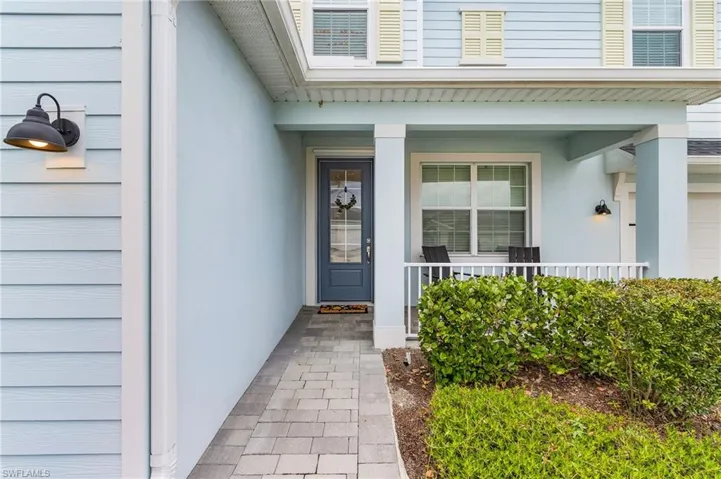 Doorway to property featuring covered porch