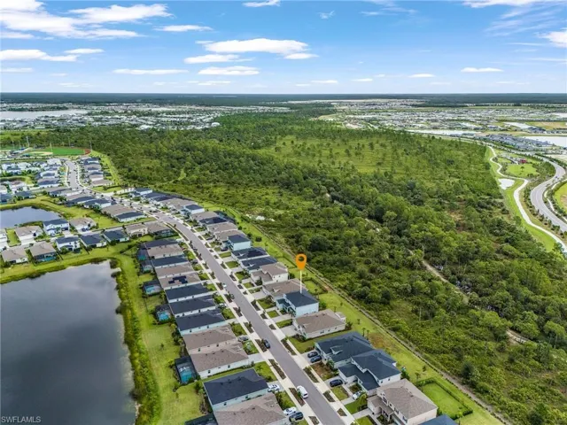 Aerial view of residential area featuring a nearby body of water