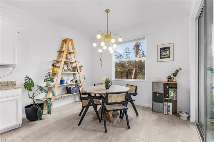 Dining room featuring ornamental molding and a chandelier