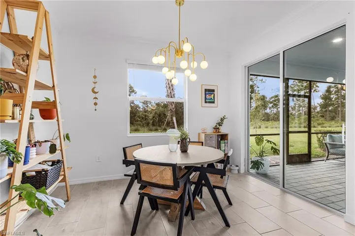 Dining area featuring ornamental molding, a chandelier, and wood tiled floors