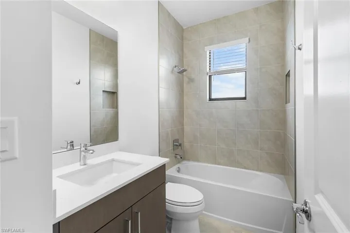 Full bath featuring  shower combination and vanity