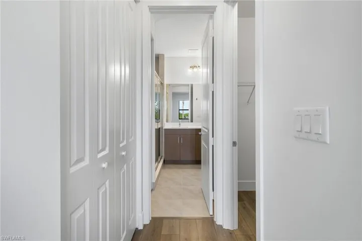 Hall with light wood finished floors