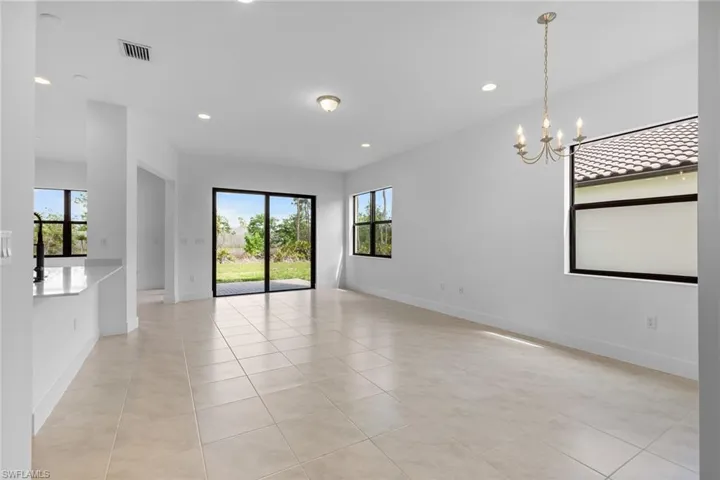 Unfurnished room featuring light tile patterned floors and suspended lighting