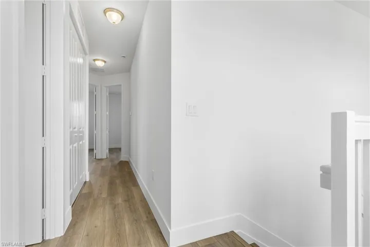 Hallway featuring baseboards and light wood finished floors