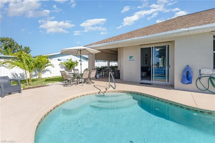 Outdoor swimming pool with integrated steps and a surrounding concrete patio