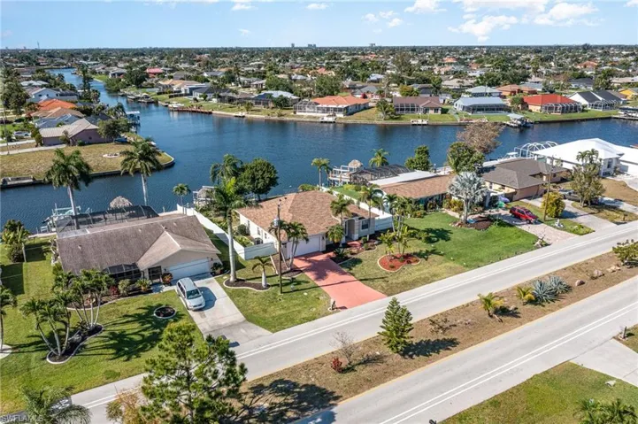 Aerial perspective showcasing a canal-front property with a private dock