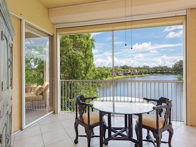 Sunroom / solarium featuring a water view