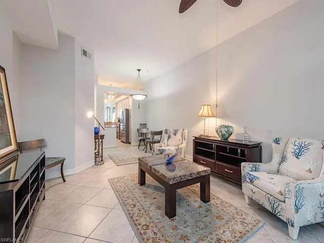 Living room with light tile patterned floors and ceiling fan