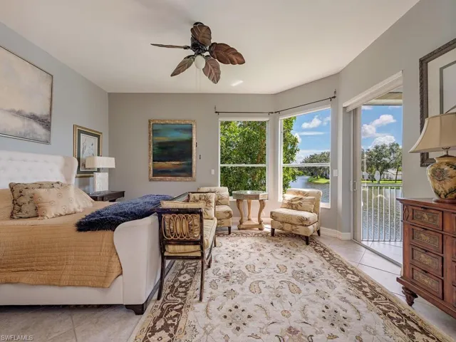 Bedroom featuring access to outside, tile patterned flooring, and ceiling fan