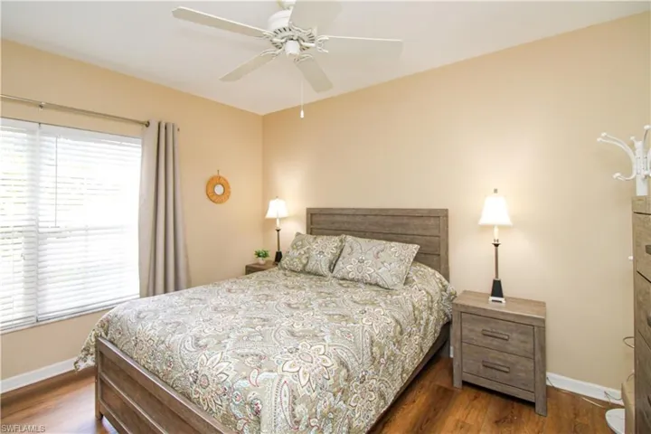 Bedroom with dark wood-type flooring and ceiling fan