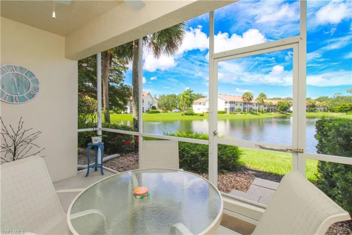 Sunroom featuring a water view