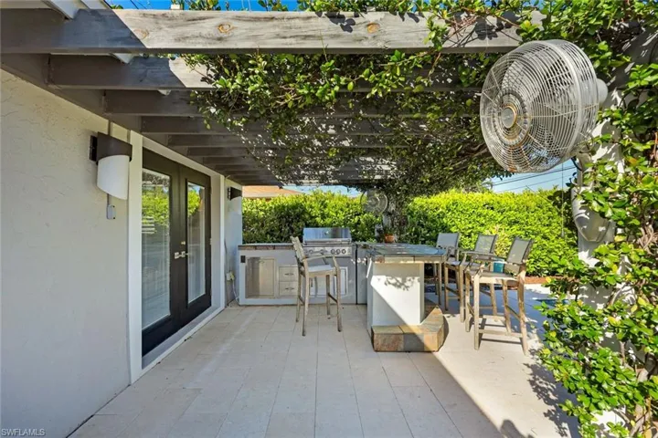 Outdoor kitchen with bar seating.