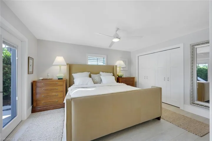 Primary bedroom with outdoor living access to pool area.