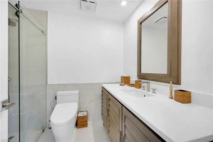 Primary bathroom, frameless shower.