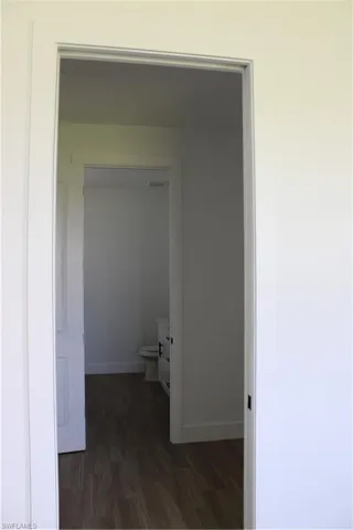 Bathroom with dark wood finished floors and vanity